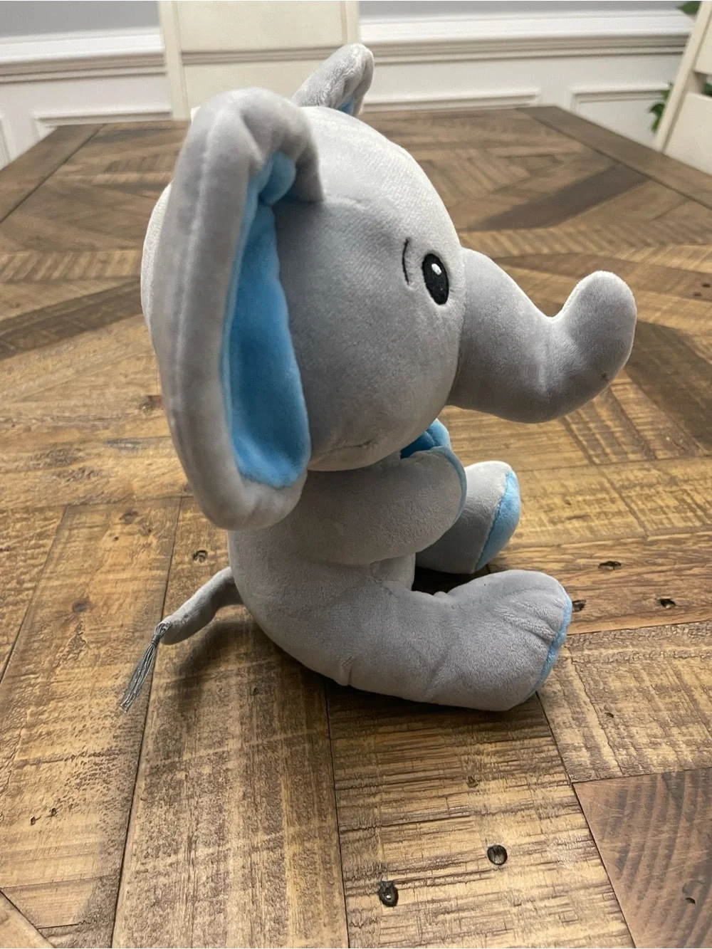 Amscan plush elephant balloon weight featuring blue ears and blue feet